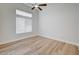 Bright bedroom features wood-look flooring, modern ceiling fan, and large windows at 7460 Desert Flame Ct, Las Vegas, NV 89149