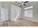 Bright bedroom features wood-look flooring, modern ceiling fan, and large closet with sliding doors at 7460 Desert Flame Ct, Las Vegas, NV 89149