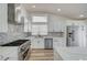 Stylish kitchen featuring stainless appliances, a spacious countertop, and tiled backsplash at 7460 Desert Flame Ct, Las Vegas, NV 89149