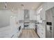 Contemporary kitchen with white cabinets, stone countertops, and modern stainless steel appliances at 7460 Desert Flame Ct, Las Vegas, NV 89149