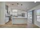 Modern kitchen with sleek white cabinets, stainless steel appliances, and an island at 7460 Desert Flame Ct, Las Vegas, NV 89149