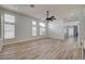 Spacious living room with recessed lights, ceiling fan and multiple windows allowing plenty of natural light at 7460 Desert Flame Ct, Las Vegas, NV 89149