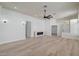 Open-concept living room boasts a sleek electric fireplace, recessed lighting, and neutral color palette at 7460 Desert Flame Ct, Las Vegas, NV 89149
