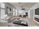 Bright living room with modern decor, large windows, and a cozy fireplace at 7460 Desert Flame Ct, Las Vegas, NV 89149