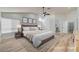 This primary bedroom features a ceiling fan, neutral walls, and ensuite access at 7460 Desert Flame Ct, Las Vegas, NV 89149