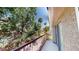 Private balcony with a view of the well-maintained lawn and lush trees in the neighborhood at 76 Stock Option St # 2, Henderson, NV 89074