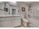 Bright bathroom with white vanity, framed mirror and shower over tub at 76 Stock Option St # 2, Henderson, NV 89074