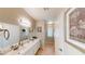 Bright bathroom boasts double sinks, large mirror, and modern fixtures at 76 Stock Option St # 2, Henderson, NV 89074