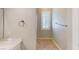 Neutral bathroom featuring a window with shutters, tile floors, and a vanity with bright lighting at 76 Stock Option St # 2, Henderson, NV 89074