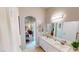 Bathroom featuring double sinks and vanity, with an archway leading to bedroom at 76 Stock Option St # 2, Henderson, NV 89074