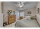 Cozy bedroom with a decorative mirror over the dresser and neutral color palette at 76 Stock Option St # 2, Henderson, NV 89074
