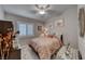 Comfortable bedroom with neutral tones, a ceiling fan, and plantation shutters at 76 Stock Option St # 2, Henderson, NV 89074