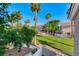 Scenic view of the neighborhood showcases mature palm trees, green spaces, and well-maintained landscaping at 76 Stock Option St # 2, Henderson, NV 89074