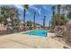 Refreshing community pool surrounded by palm trees and lounge chairs at 76 Stock Option St # 2, Henderson, NV 89074