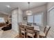 Dining area with modern light fixture, seating for four, and ample natural light at 76 Stock Option St # 2, Henderson, NV 89074