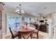 Cozy dining area features a round wood table, seating for six, and bright natural light at 76 Stock Option St # 2, Henderson, NV 89074