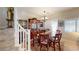 Charming dining room showcasing a wood table set, hutch, chandelier, and staircase at 76 Stock Option St # 2, Henderson, NV 89074