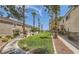 Scenic greenbelt featuring manicured lawns, mature landscaping, and sidewalks at 76 Stock Option St # 2, Henderson, NV 89074