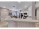 Updated kitchen with quartz countertops, stainless appliances, and breakfast bar overlooking the dining area at 76 Stock Option St # 2, Henderson, NV 89074