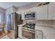 Updated kitchen features stainless steel appliances, gas range, and sleek countertops at 76 Stock Option St # 2, Henderson, NV 89074