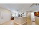 Open concept kitchen features white cabinets, stainless steel appliances, and eat-in dining area at 76 Stock Option St # 2, Henderson, NV 89074