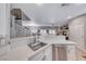 Open-concept kitchen boasts sleek countertops and stainless-steel appliances, blending seamlessly with the living area at 76 Stock Option St # 2, Henderson, NV 89074