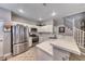Modern kitchen with stainless steel appliances, white cabinetry, and an adjoining carpeted staircase at 76 Stock Option St # 2, Henderson, NV 89074