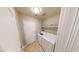 Convenient laundry room with washer, dryer, shelving, and direct access to outside at 76 Stock Option St # 2, Henderson, NV 89074