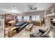 Comfortable living room with leather seating, ceiling fan, and view into the dining area at 76 Stock Option St # 2, Henderson, NV 89074