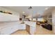 Open concept living room features kitchen view, natural light, and modern decor at 76 Stock Option St # 2, Henderson, NV 89074
