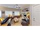 Comfortable living room boasts leather sofas, ceiling fan, built-in shelves, and windows with plantation shutters at 76 Stock Option St # 2, Henderson, NV 89074