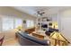 Comfortable living room features leather sofas, ceiling fan, built-in shelves, and windows with plantation shutters at 76 Stock Option St # 2, Henderson, NV 89074