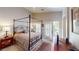 Bedroom with four poster bed, sitting area, balcony doors and natural lighting at 76 Stock Option St # 2, Henderson, NV 89074