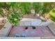 Private brick-paved patio enclosed with a white fence and framed by trees, perfect for outdoor relaxation at 76 Stock Option St # 2, Henderson, NV 89074