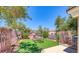 Charming picnic area with green synthetic lawn, picnic table, benches and mature trees at 76 Stock Option St # 2, Henderson, NV 89074