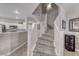 Carpeted staircase with white railing leads to the upper level, bathed in natural light at 76 Stock Option St # 2, Henderson, NV 89074