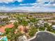 An aerial view showcasing a home with tile roof, swimming pool, and desert landscaping at 7730 Brambly Creek Ct, Las Vegas, NV 89129