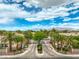 Gated community entrance with lush landscaping and serene mountain views in the background at 7730 Brambly Creek Ct, Las Vegas, NV 89129