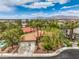 Expansive aerial view of a home with a tile roof, a two-car garage, mature trees, and a swimming pool at 7730 Brambly Creek Ct, Las Vegas, NV 89129