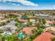 Aerial view features the swimming pool, the tile roof, and desert landscaping at 7730 Brambly Creek Ct, Las Vegas, NV 89129