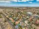 A wide aerial view of a community with diverse homes, streets, landscaping, and neighborhood amenities at 7730 Brambly Creek Ct, Las Vegas, NV 89129