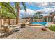 This backyard features a refreshing pool, comfortable seating, and a charming fire pit perfect for outdoor relaxation at 7730 Brambly Creek Ct, Las Vegas, NV 89129