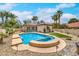 An outdoor pool and spa with ample seating surrounded by lush landscaping at 7730 Brambly Creek Ct, Las Vegas, NV 89129