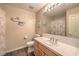 Bright bathroom with nautical decor, a vanity with sink, tile floors, and a shower at 7730 Brambly Creek Ct, Las Vegas, NV 89129