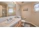 Bright bathroom featuring a shower, sink and vanity, with light wood cabinets at 7730 Brambly Creek Ct, Las Vegas, NV 89129