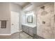 Modern bathroom features a large shower with marble tile, a vanity and a linen closet at 7730 Brambly Creek Ct, Las Vegas, NV 89129