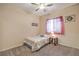 Simple bedroom with a bed, carpet floors, a ceiling fan, and natural light from the window at 7730 Brambly Creek Ct, Las Vegas, NV 89129