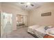 Bedroom with a mirrored closet, carpet, ceiling fan, and decor, creating a cozy space at 7730 Brambly Creek Ct, Las Vegas, NV 89129