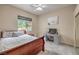 Comfortable bedroom with a cozy bed, ceiling fan, carpet floors, and a window view at 7730 Brambly Creek Ct, Las Vegas, NV 89129