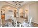 Charming dining area featuring a farmhouse table, archways, and decorative accents at 7730 Brambly Creek Ct, Las Vegas, NV 89129